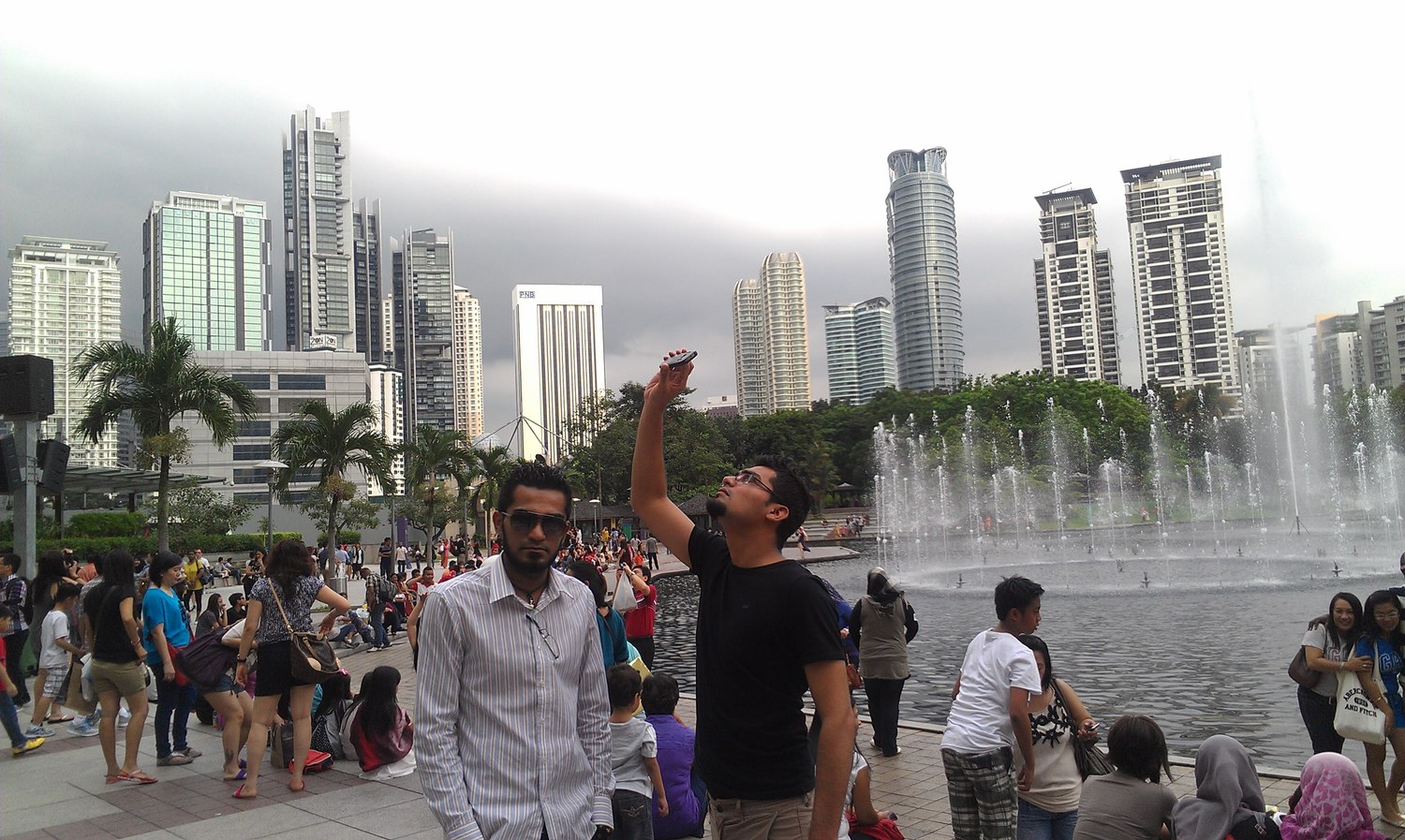Naveed at the KLCC fountains with the skyline behind him
